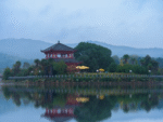 Peaceful lakeside temple with mountain reflection